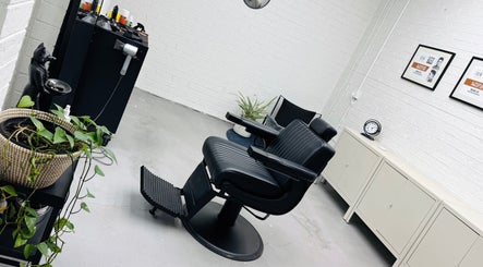 Modern barber chair at Ash Bang, Melbourne, Victoria, AU with stylish decor and sleek equipment.