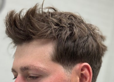 Trendy men's haircut at Ash Bang, Melbourne, Victoria, AU showcasing textured quiff style.