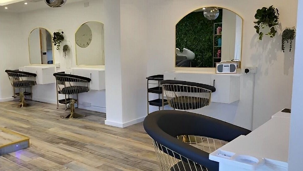 Modern salon interior at Reflection Hair and Beauty Norwich, located in Norwich, England, GB, featuring stylish chairs.