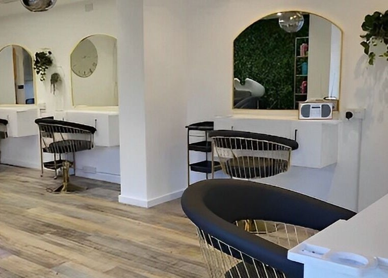 Modern salon interior at Reflection Hair and Beauty Norwich, located in Norwich, England, GB, featuring stylish chairs.