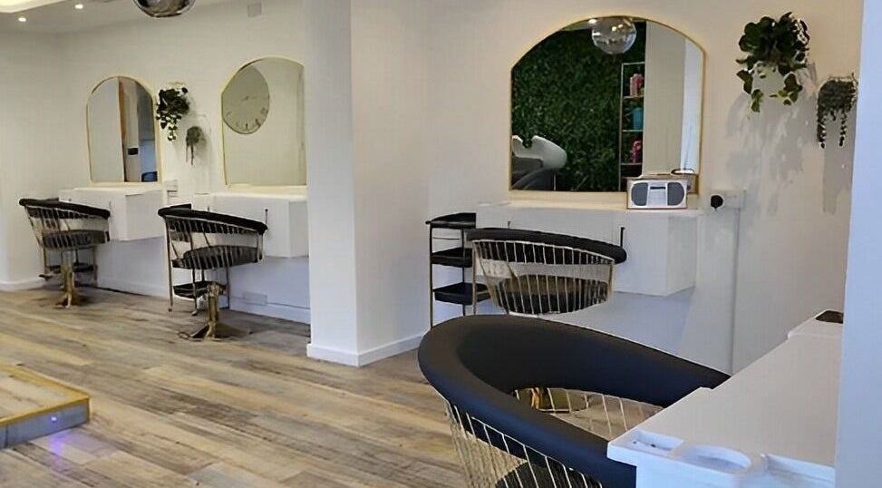Modern salon interior at Reflection Hair and Beauty Norwich, located in Norwich, England, GB, featuring stylish chairs.