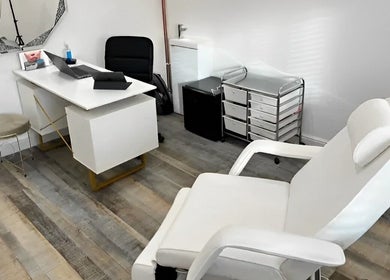 Modern treatment room at Reflection Hair and Beauty Norwich, Norwich, England, GB with sleek white furniture.