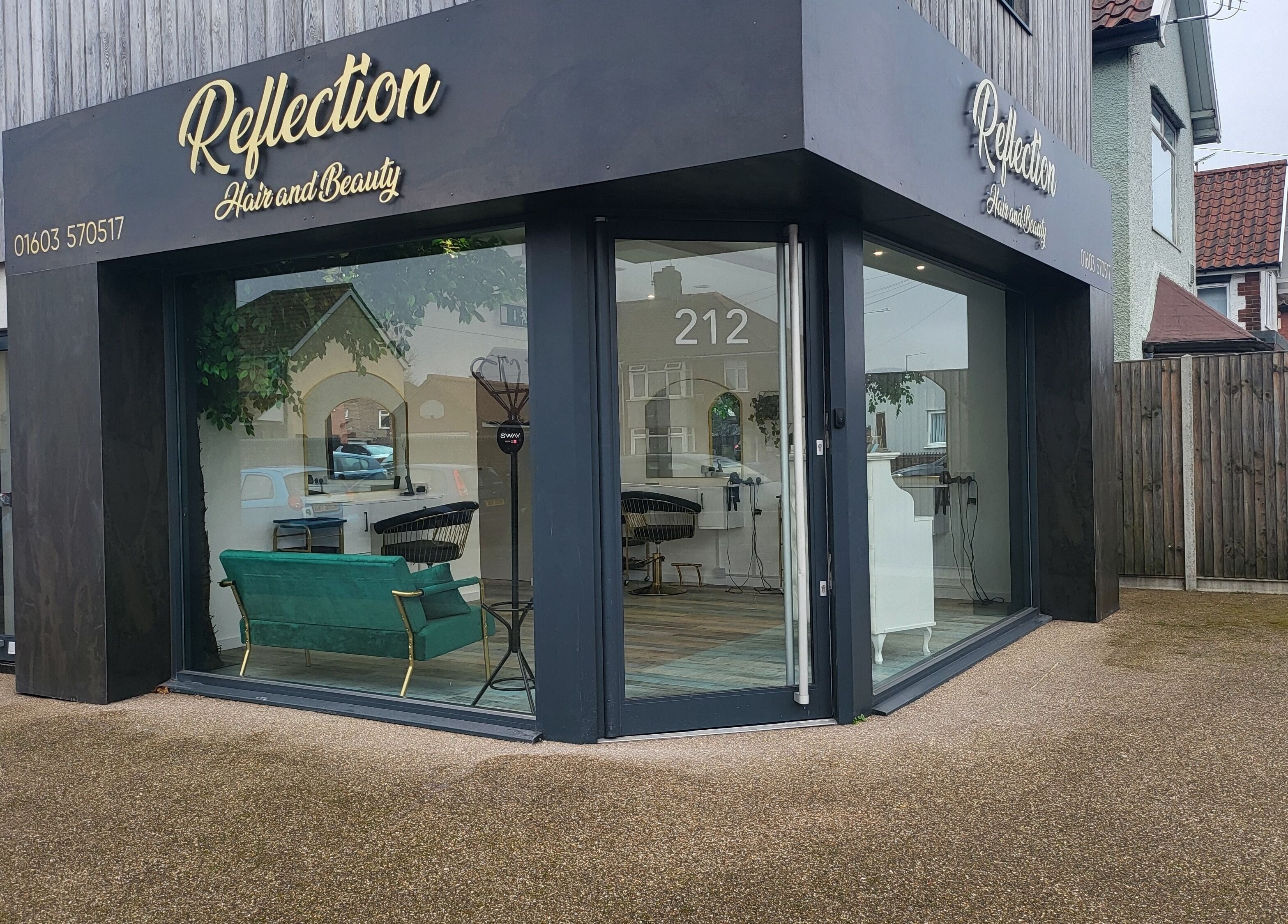 Entrance of Reflection Hair and Beauty Norwich, located in Norwich, England, GB with modern glass facade.