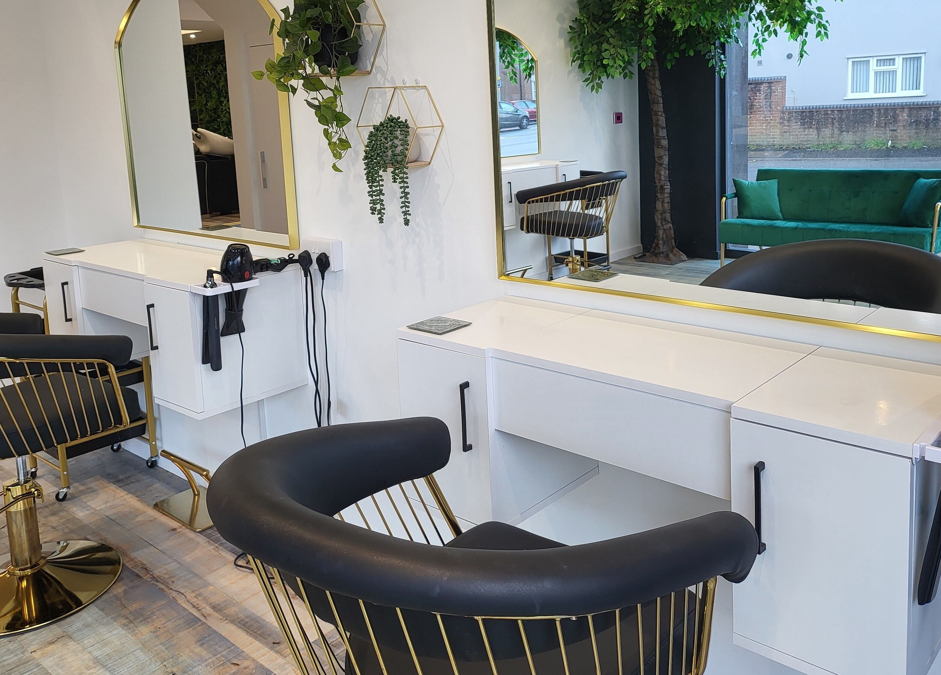 Elegant styling stations at Reflection Hair and Beauty Norwich, Norwich, England, GB, with plush seating and mirrors.