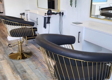 Modern salon chairs at Reflection Hair and Beauty Norwich, Norwich, England, GB offer style and comfort.