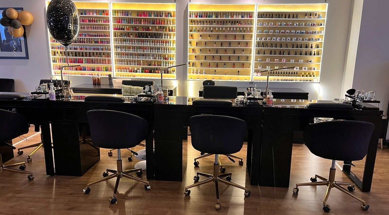 Interior of Humaz Nail and Beauty showcasing nail polish displays in Sutton, England, GB.