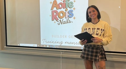 Workshop at Aoife Rois Nails, Newtownabbey with presenter, showcasing training manual on screen.