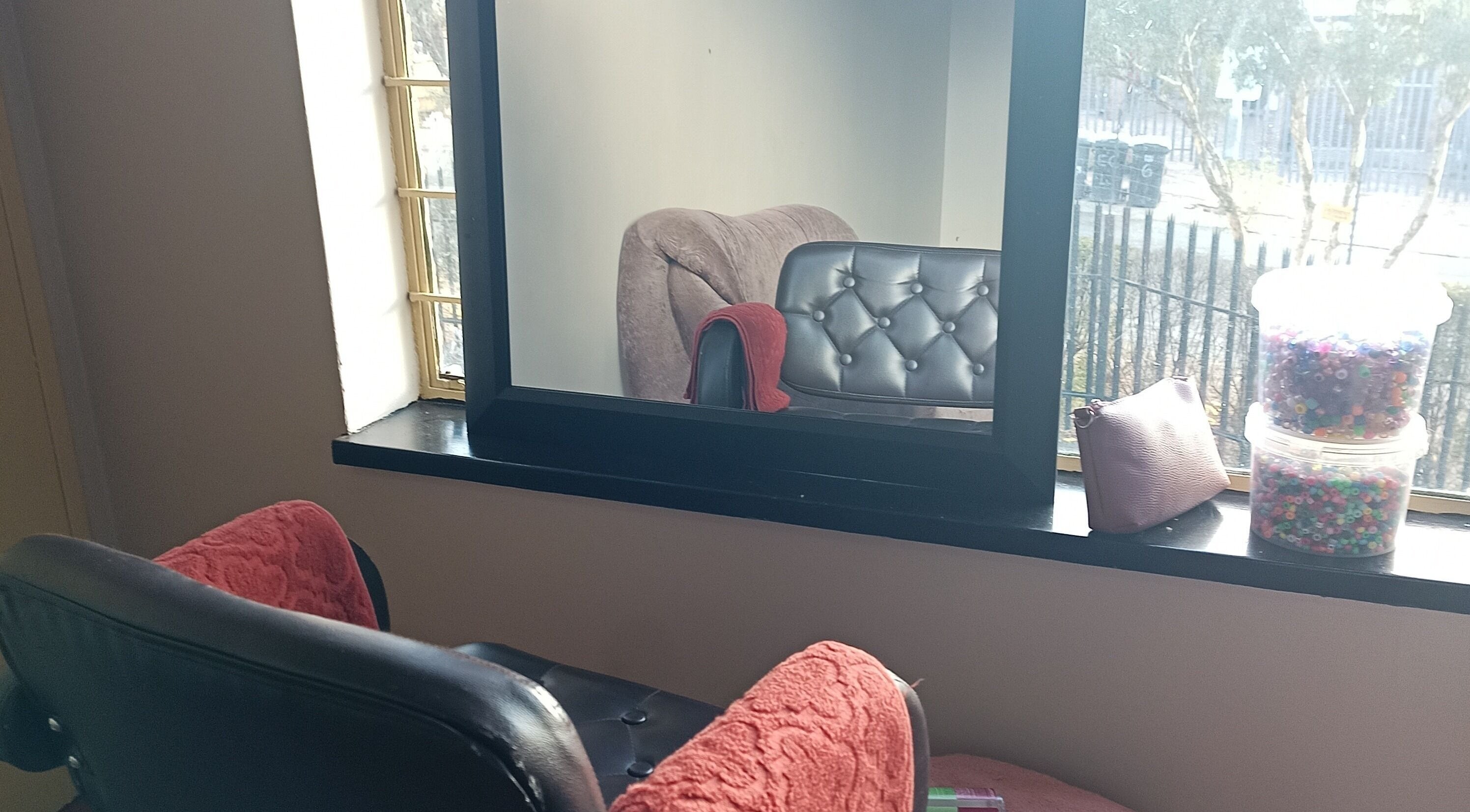 Inviting salon chairs by the window at Shimatsatsa Kids And Family Salon, Randburg, Gauteng, ZA.