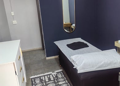 Serene treatment room at Pruddy's Beauty Studio, Benoni, Gauteng, ZA with bed and minimalist decor.