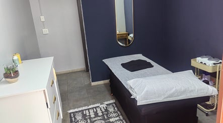 Serene treatment room at Pruddy's Beauty Studio, Benoni, Gauteng, ZA with bed and minimalist decor.