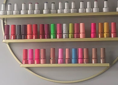 Colorful nail polish shelves at Pruddy's Beauty Studio, Benoni, Gauteng, ZA. A vivid beauty collection.