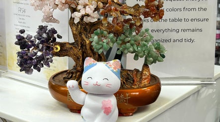 A colorful gemstone bonsai tree with lucky cat at Ten Perfect Nail Design, Lowell, Massachusetts, US.