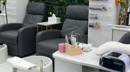 Manicure station with plush chairs at Angel Glow by Vesi, London, GB. Modern and inviting beauty salon decor.