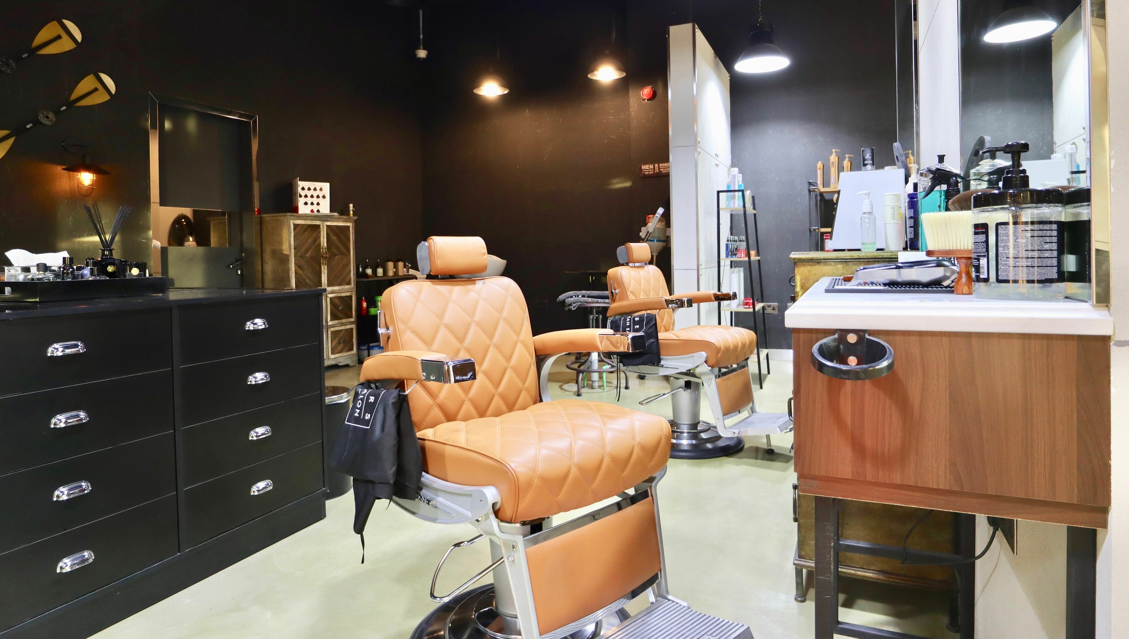Luxurious leather chairs at Barbers Gentlemen Saloon, Dubai, AE offer a premium grooming experience.