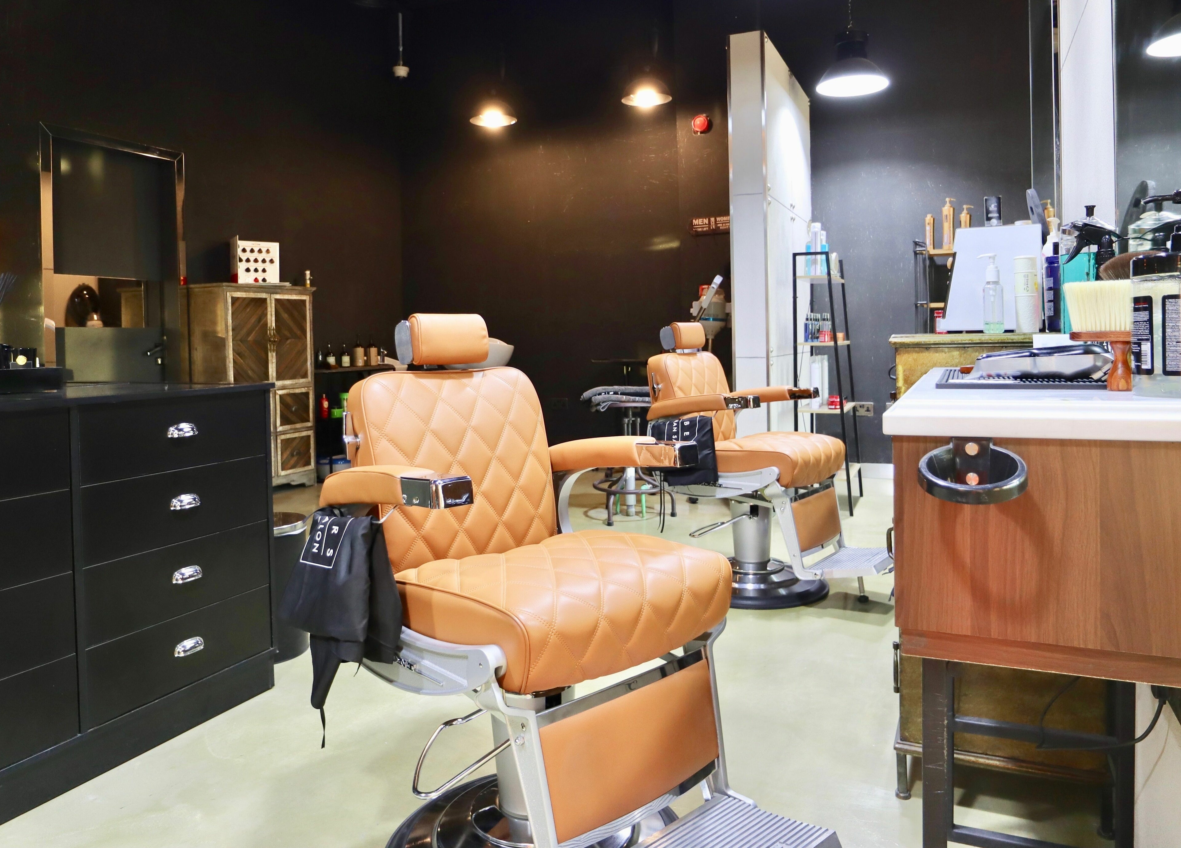 Luxurious leather chairs at Barbers Gentlemen Saloon, Dubai, AE offer a premium grooming experience.