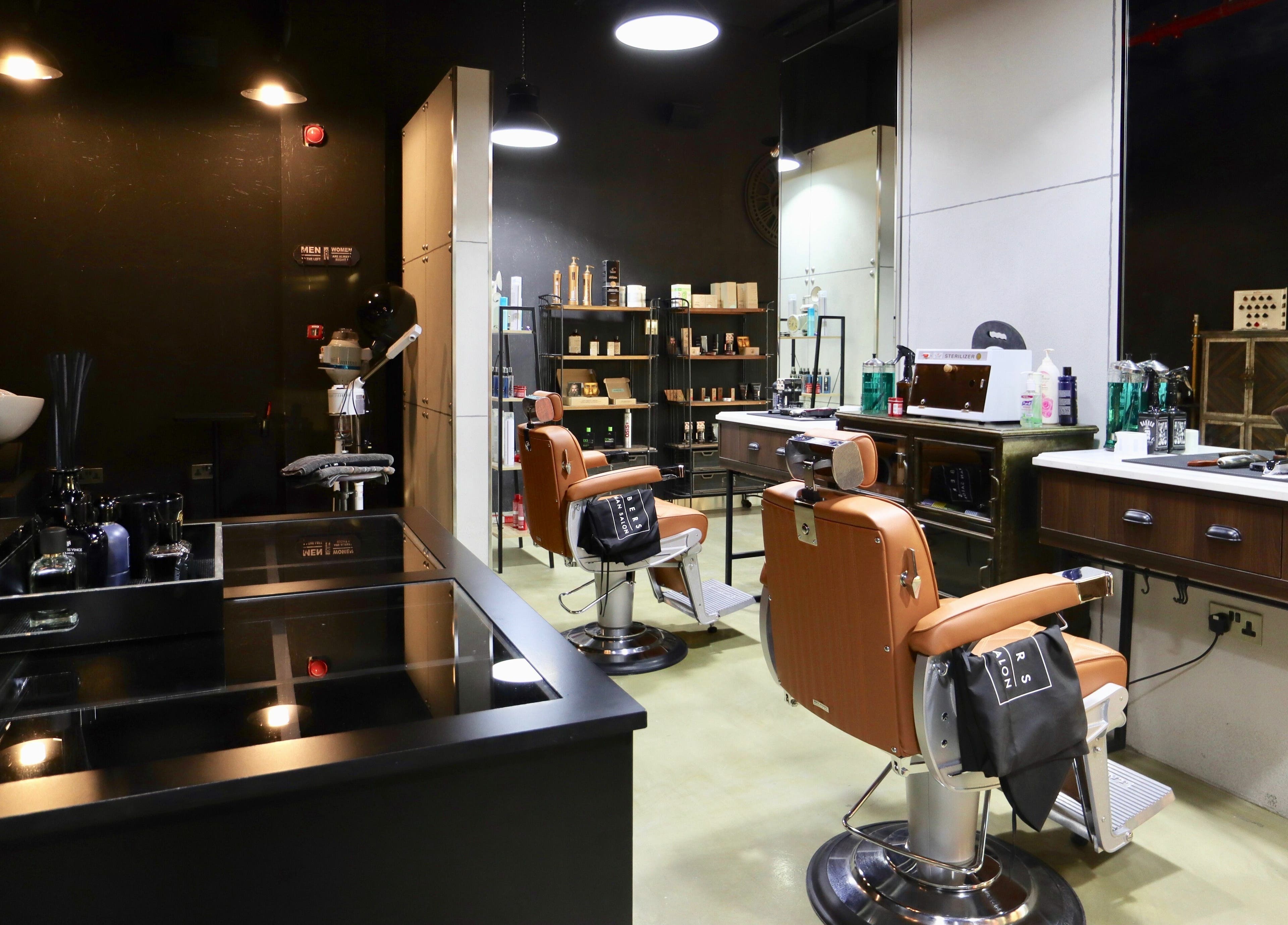 Stylish interior of Barbers Gentlemen Saloon in Dubai, AE showcasing modern barber chairs and grooming products.