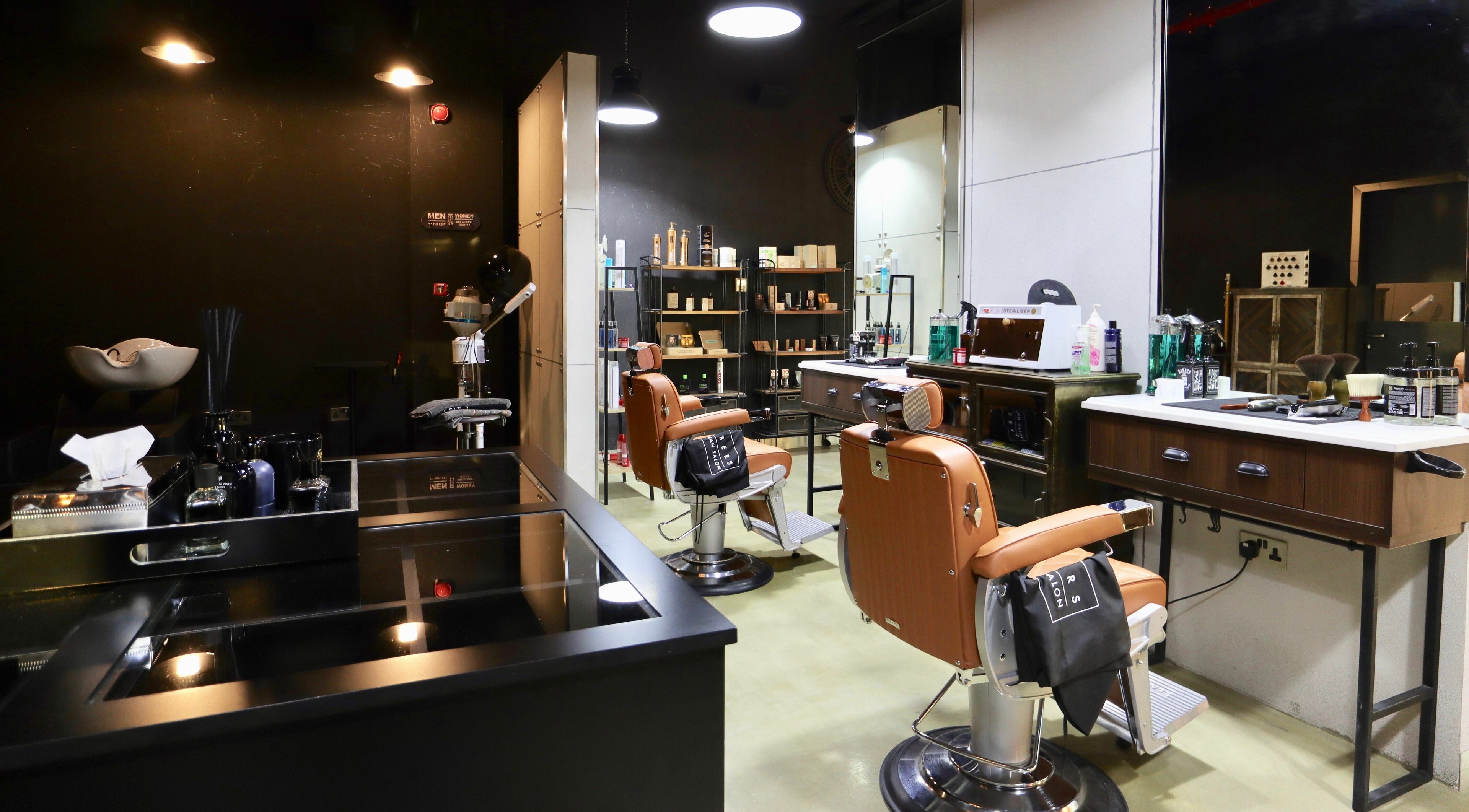 Stylish interior of Barbers Gentlemen Saloon in Dubai, AE showcasing modern barber chairs and grooming products.