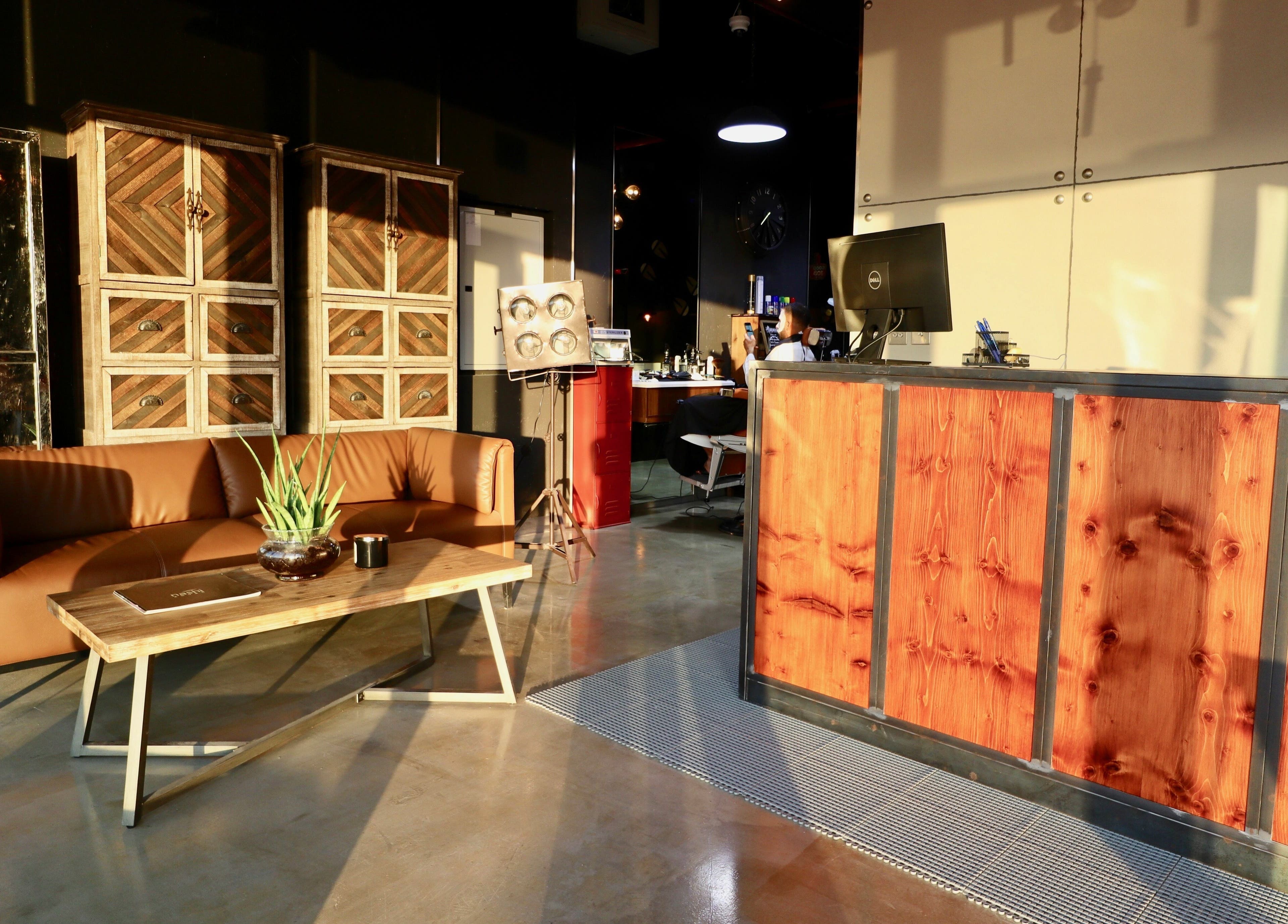 Reception area at Barbers Gentlemen Saloon, Dubai, AE with elegant decor and comfortable seating.
