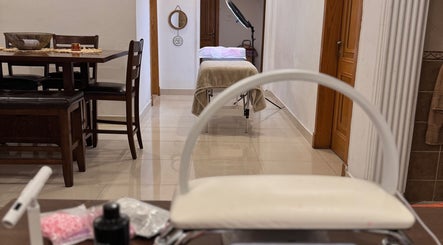 Chic beauty therapy room at The Beauty Spot, Jeddah, SA, with a massage table and stylish decor.