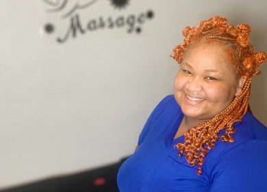 Smiling stylist at Studio Delights, Nassau, New Providence, BS offering beauty services.