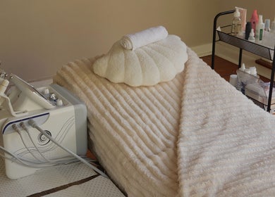 Relaxing treatment room at Young Aesthetic Solutions, Melbourne, Victoria, AU with soft linens and beauty equipment.