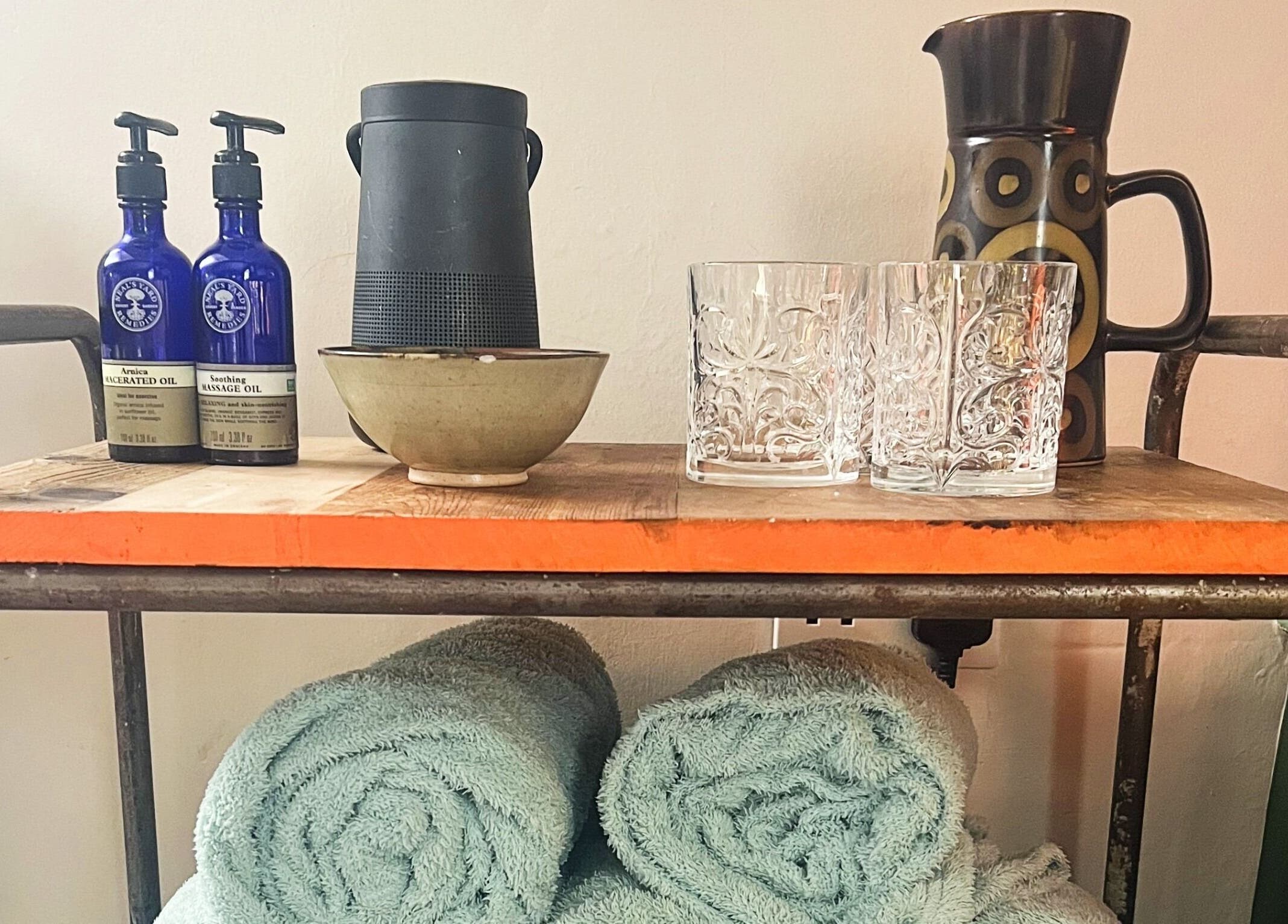 Massage oils and towels at Mountain Flow Massage, Clyro, Wales, GB, creating a serene and inviting atmosphere.
