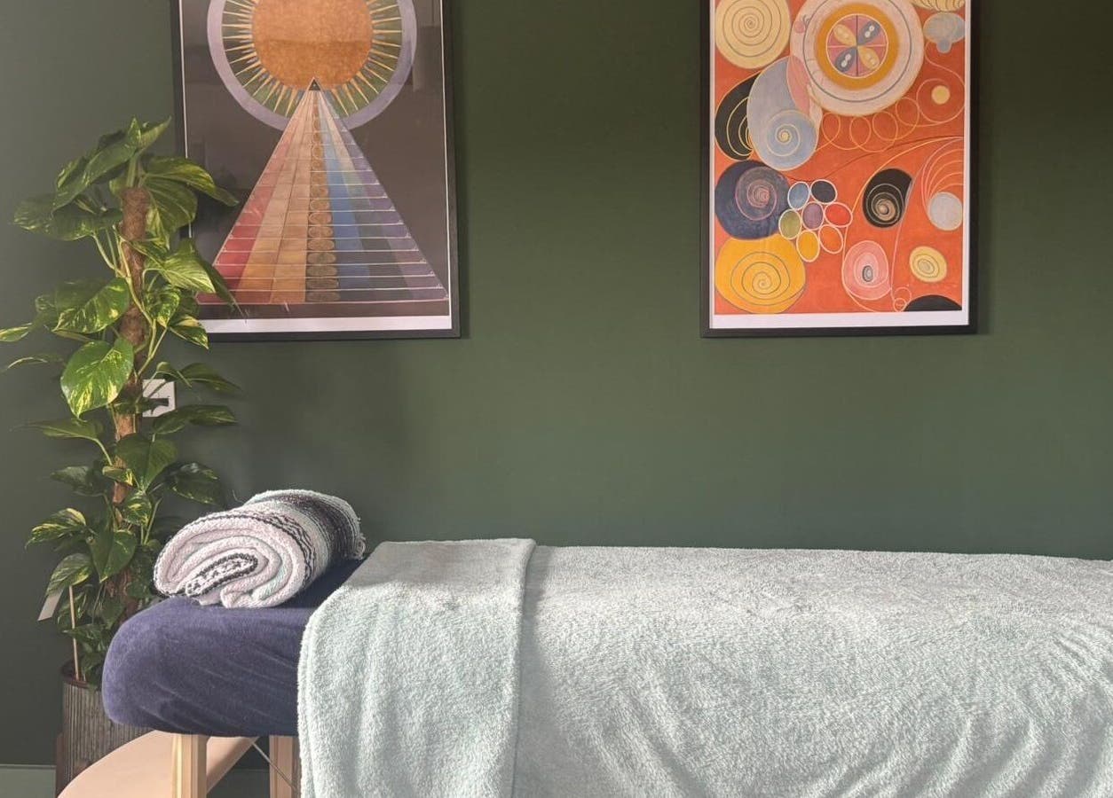 Relaxing massage table setup at Mountain Flow Massage in Clyro, Wales, GB, with calming decor and art.