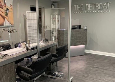 Stylish manicure station at The Retreat, Cheshunt, England, GB with modern decor and sleek workstations.