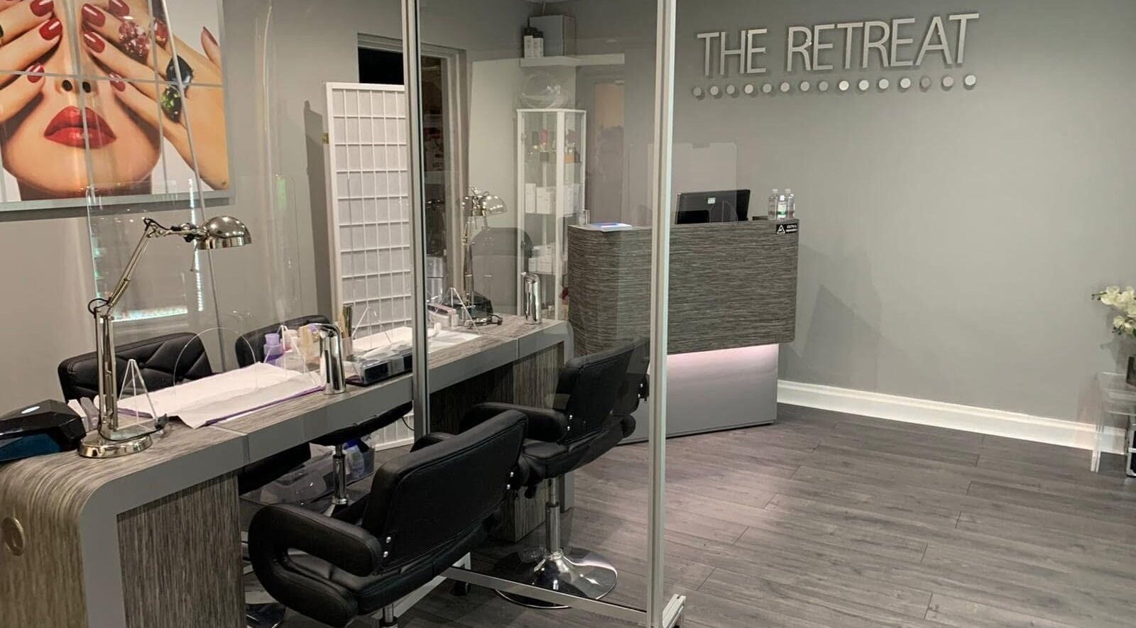 Stylish manicure station at The Retreat, Cheshunt, England, GB with modern decor and sleek workstations.