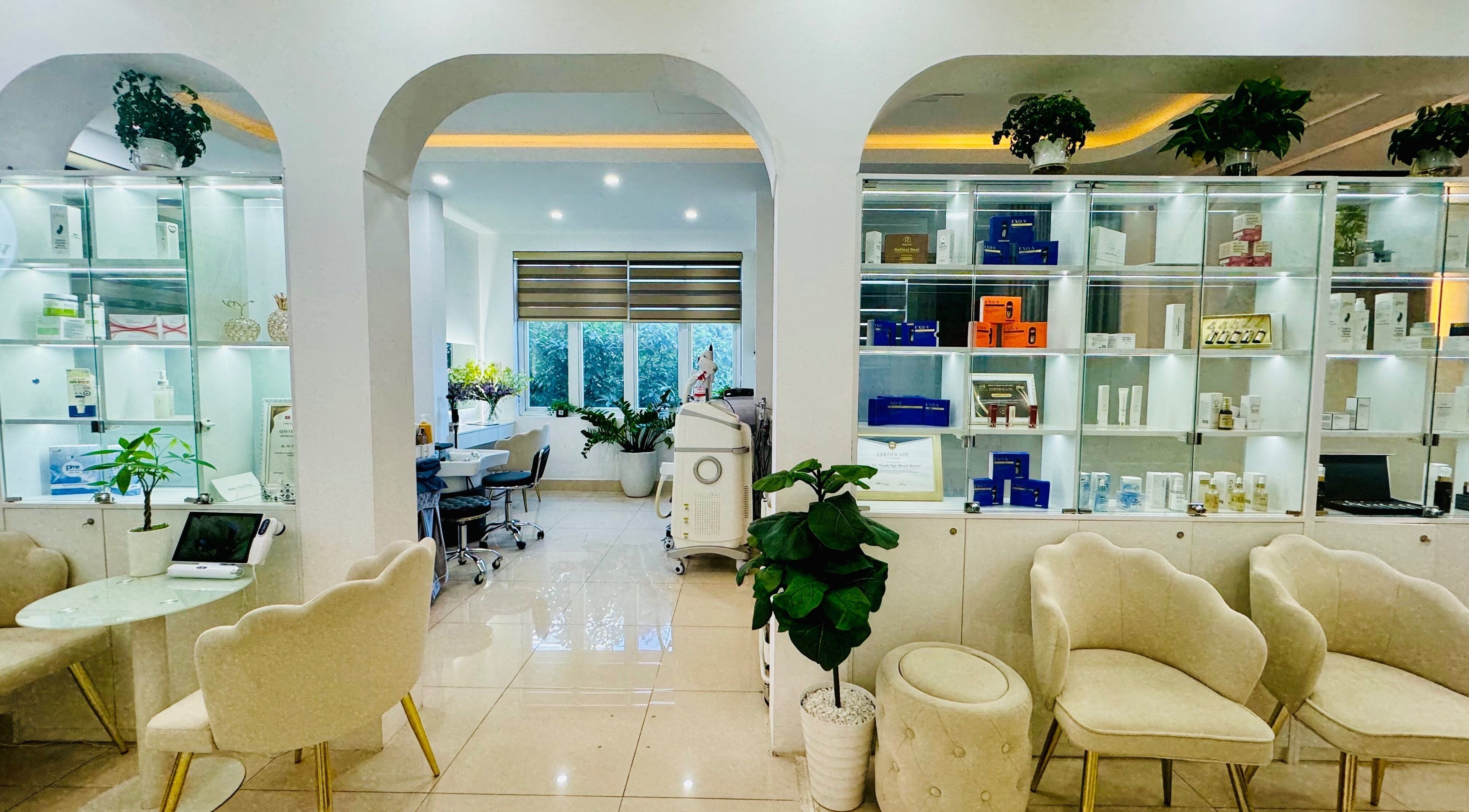 Elegant interior of Woo Korea Beauty & Spa in Hà Nội, featuring plush chairs and well-lit product displays.