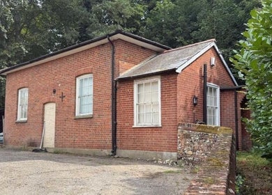 The Beauty Ritualist | Wellness Clinic, a quaint brick building in Ipswich, England, GB surrounded by lush greenery.