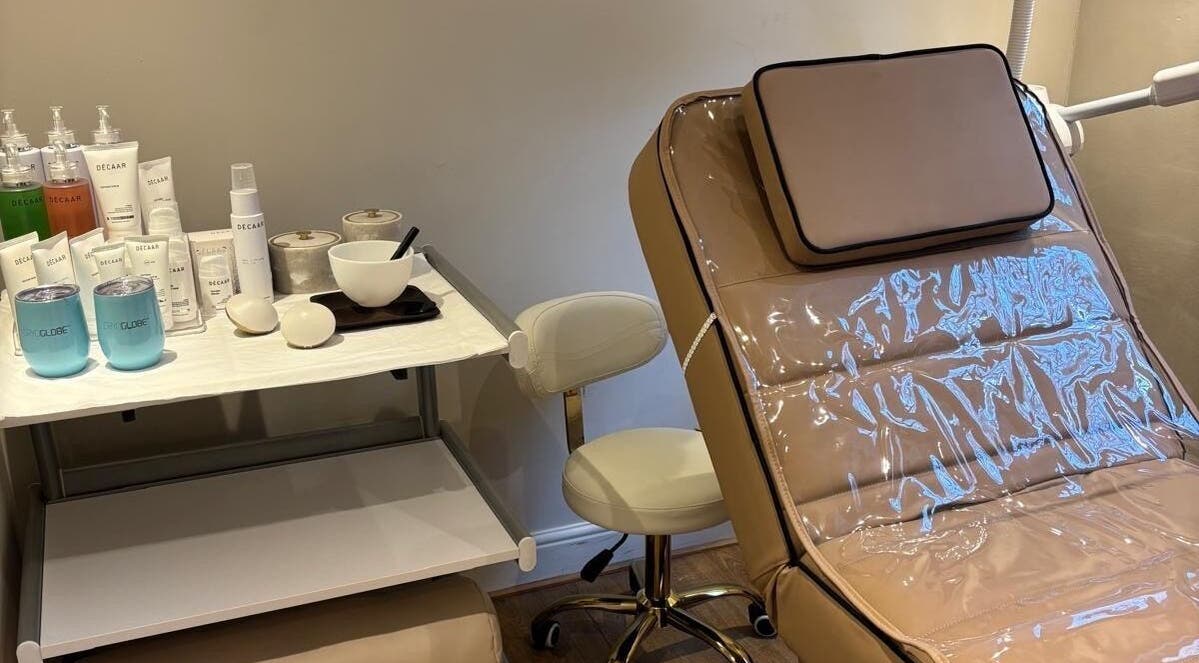Relaxing treatment room at The Beauty Ritualist | Wellness Clinic, Ipswich, England, GB with skincare products and chair.