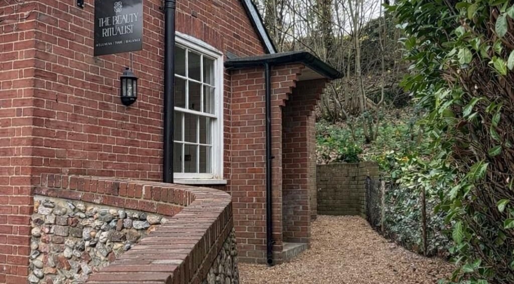 Exterior view of The Beauty Ritualist | Wellness Clinic in Ipswich, England, GB, surrounded by lush greenery.