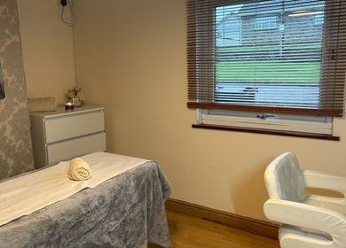 Relaxing treatment room at Homespa Nails & Beauty, Saint Columb, England, with massage bed and tranquil decor.