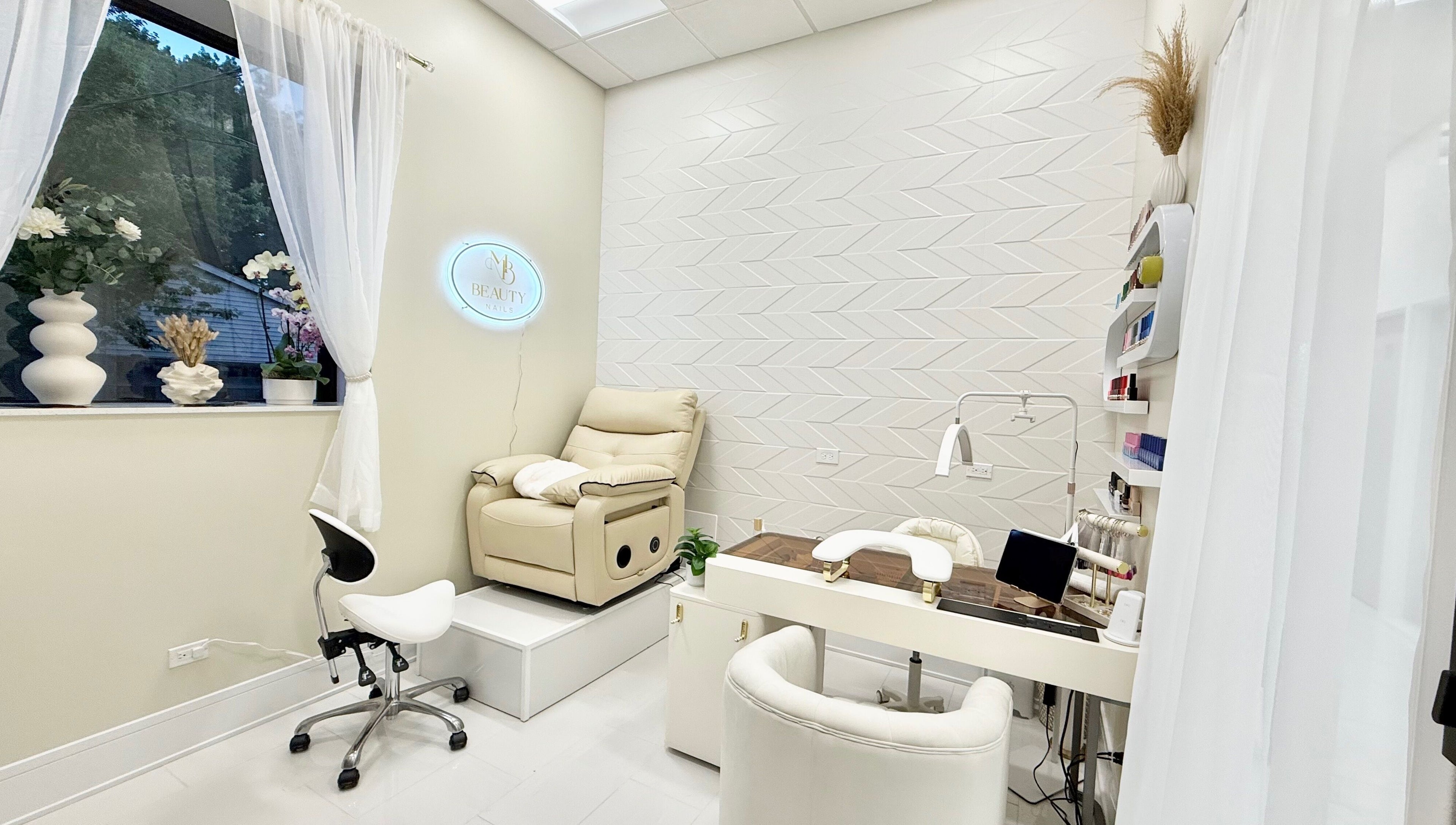 Tranquil interior of M Beauty Nails, a spa-like nail salon in Chicago, Illinois, US with plush seating.