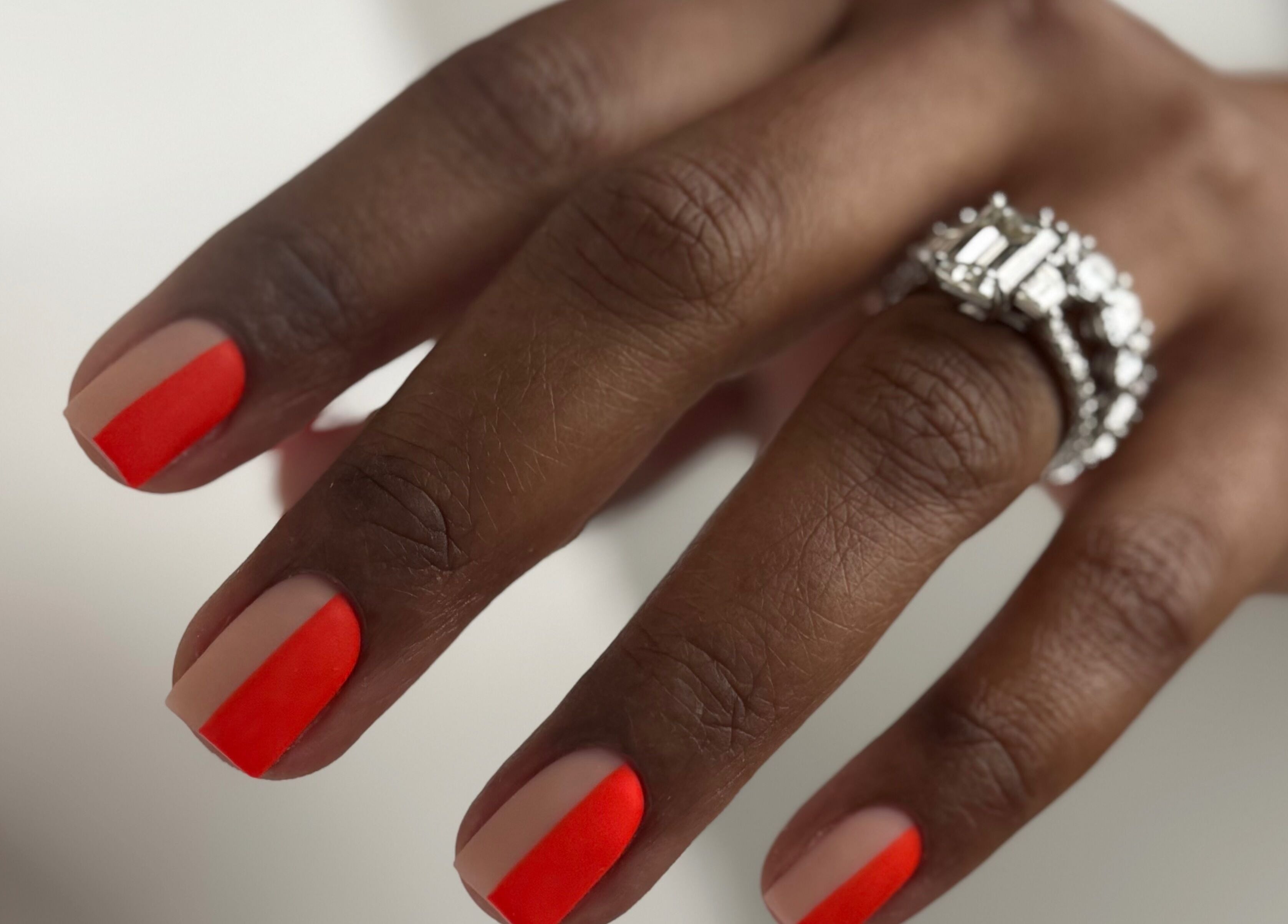 Stylish red-tipped nails with diamond ring at M Beauty Nails, Chicago, Illinois, US.