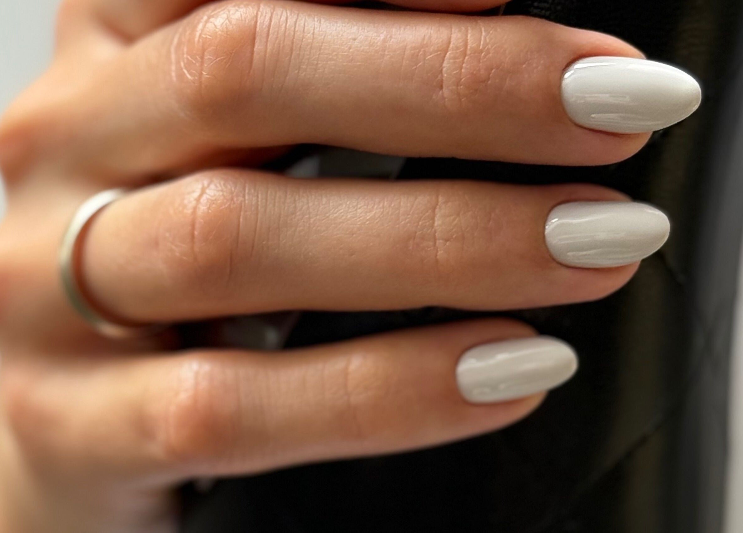 Close-up of elegant white manicure at M Beauty Nails, Chicago, Illinois, US, showcasing nail artistry.