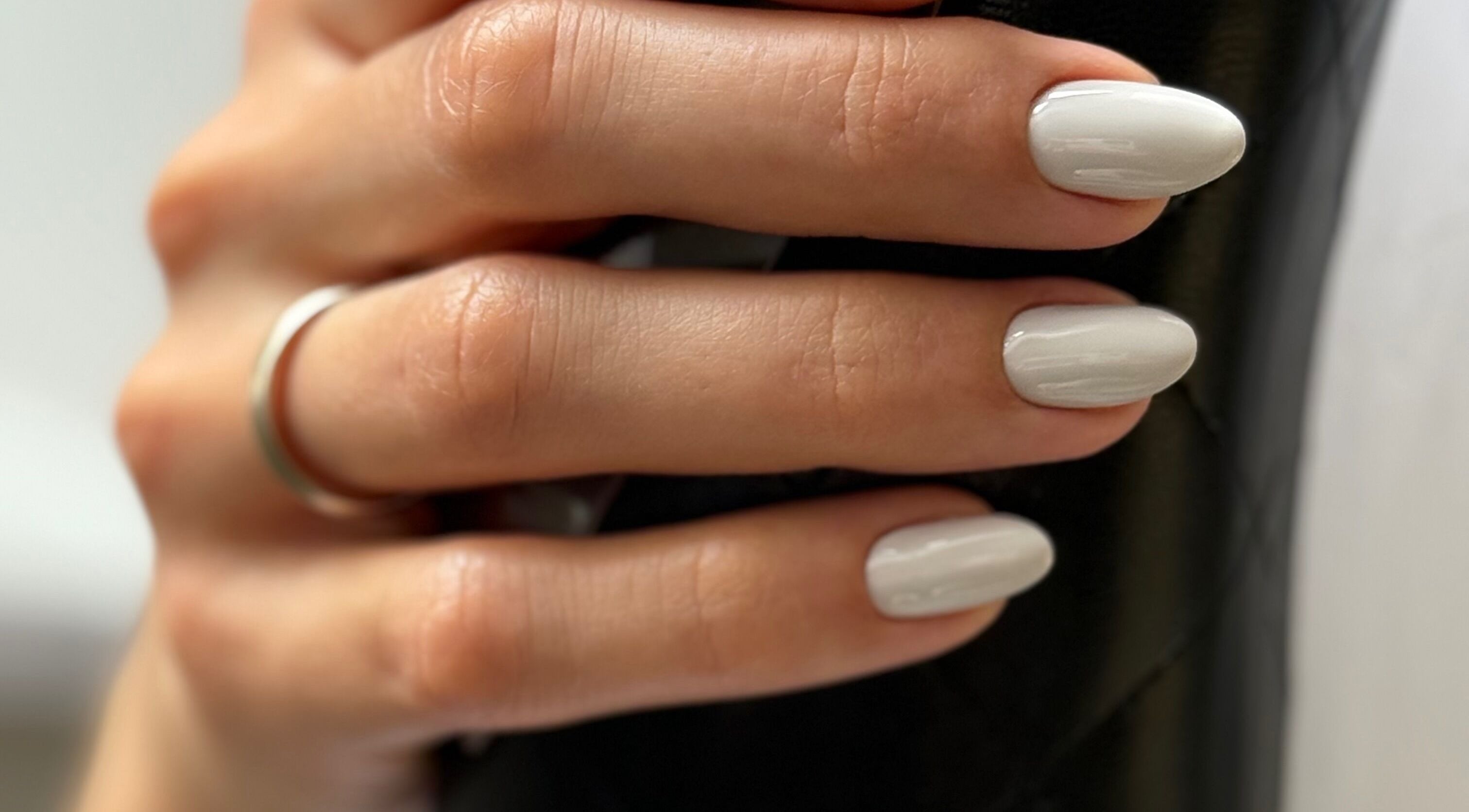 Close-up of elegant white manicure at M Beauty Nails, Chicago, Illinois, US, showcasing nail artistry.