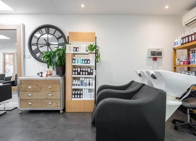 Modern salon interior at Hairbykaty, Sale, England, GB, featuring chic furniture and a welcoming atmosphere.