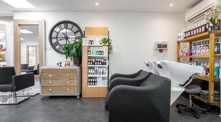 Modern salon interior at Hairbykaty, Sale, England, GB, featuring chic furniture and a welcoming atmosphere.