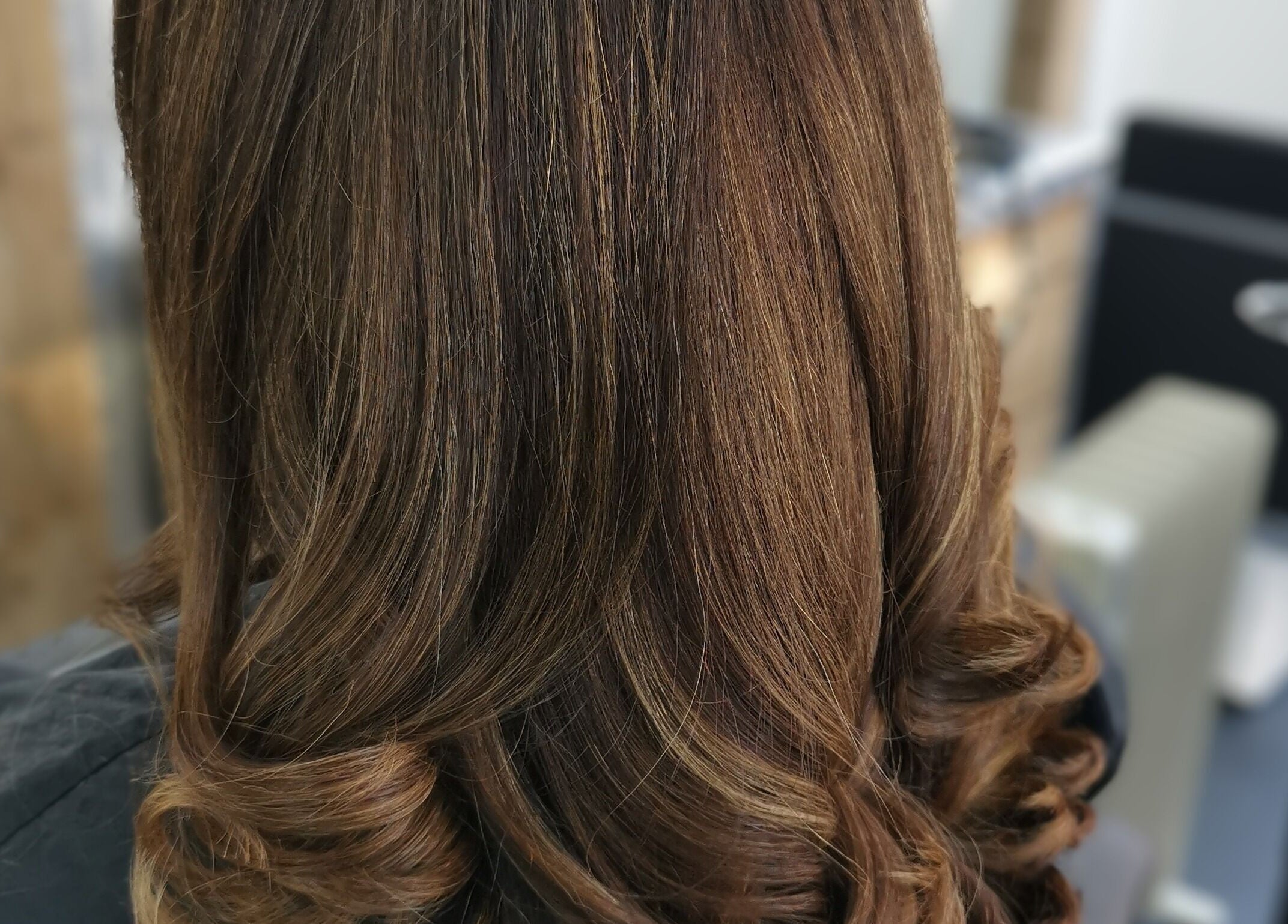 Elegant brunette curls styled at Hairbykaty in Sale, England, GB, showcasing expert salon techniques.