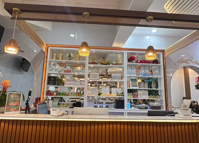 Reception at Island Nail Lounge in Houston, Texas, US with glowing lights and neatly arranged products on shelves.
