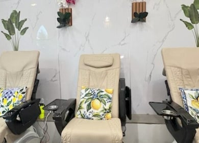 Comfortable pedicure chairs with lemon pillows at Island Nail Lounge, Houston, Texas, US.