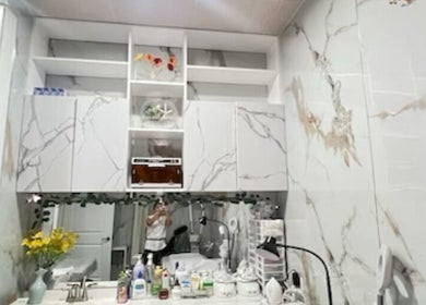 Elegant marble vanity at Island Nail Lounge in Houston, Texas, US featuring stylish storage and decor.