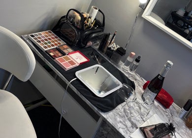Makeup station at LR Beauty in Stalybridge, England, GB with palettes, brushes, and mirror.