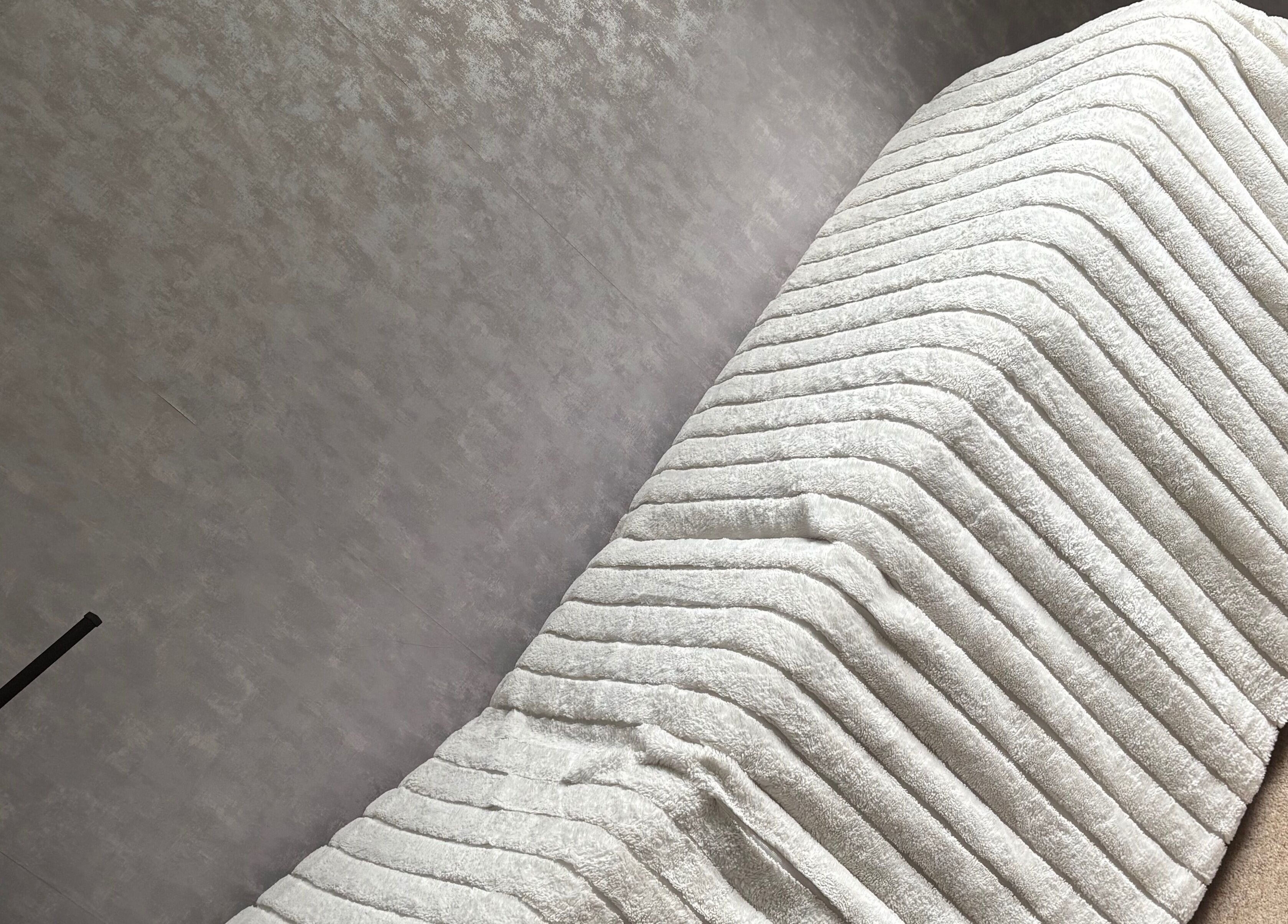 Soft white spa blanket on a massage table at LR Beauty, Mossley, England, GB, offering ultimate relaxation.