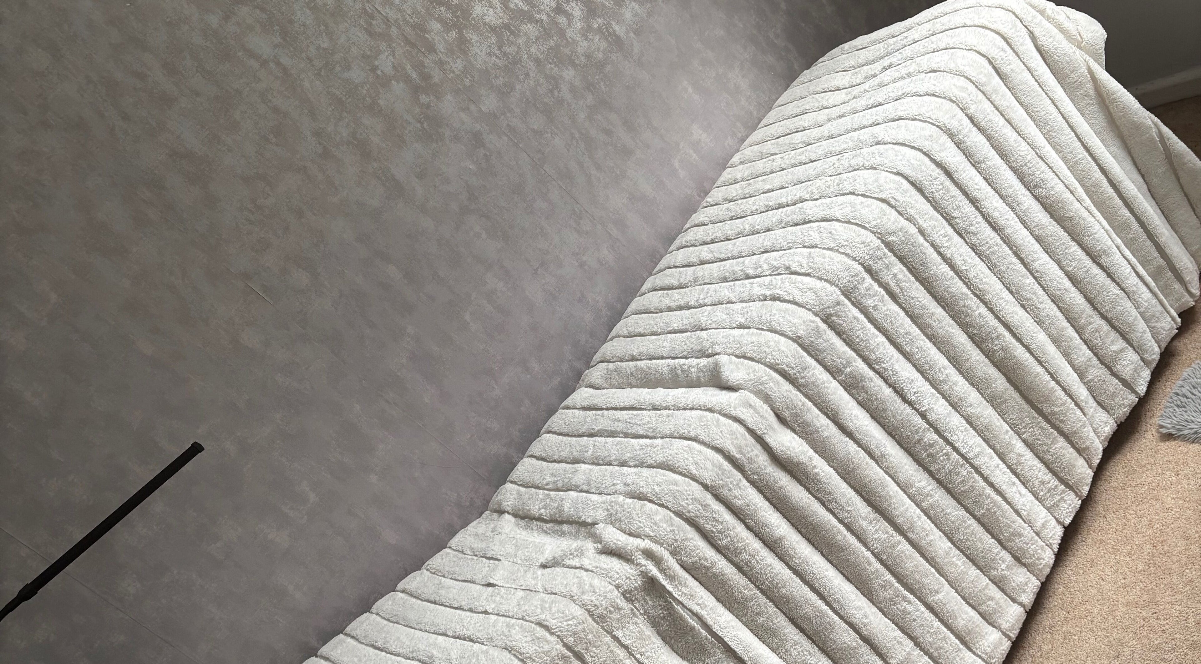 Soft white spa blanket on a massage table at LR Beauty, Mossley, England, GB, offering ultimate relaxation.