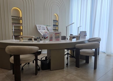 Manicure station at Dilara Beauty Salon, دبي, دبي, AE, showcasing nail polishes and stylish chairs.