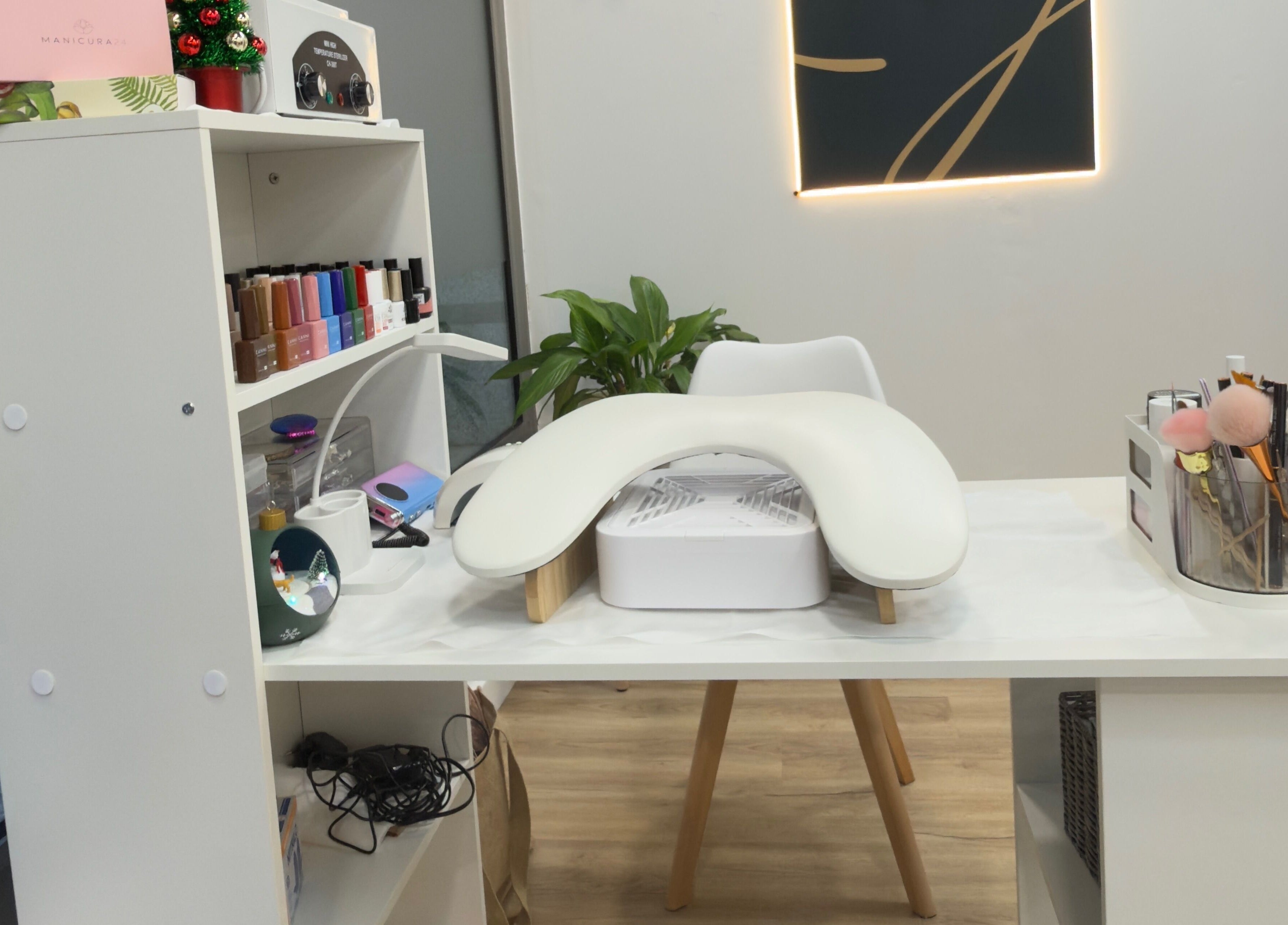 Mesa de manicura elegante en Jhovana Hair Studio, L'escala, Catalunya, ES, con esmaltes y herramientas.