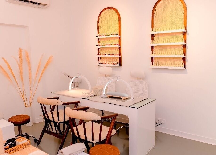 Elegant nail salon setup at Lilly's, Colombo, Western Province, LK, featuring stylish chairs and shelves.